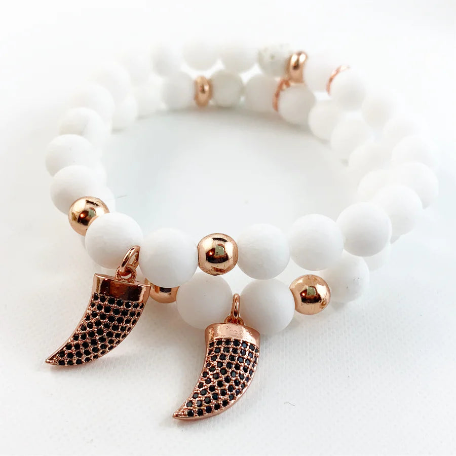 white beaded bracelet with gold horn charm